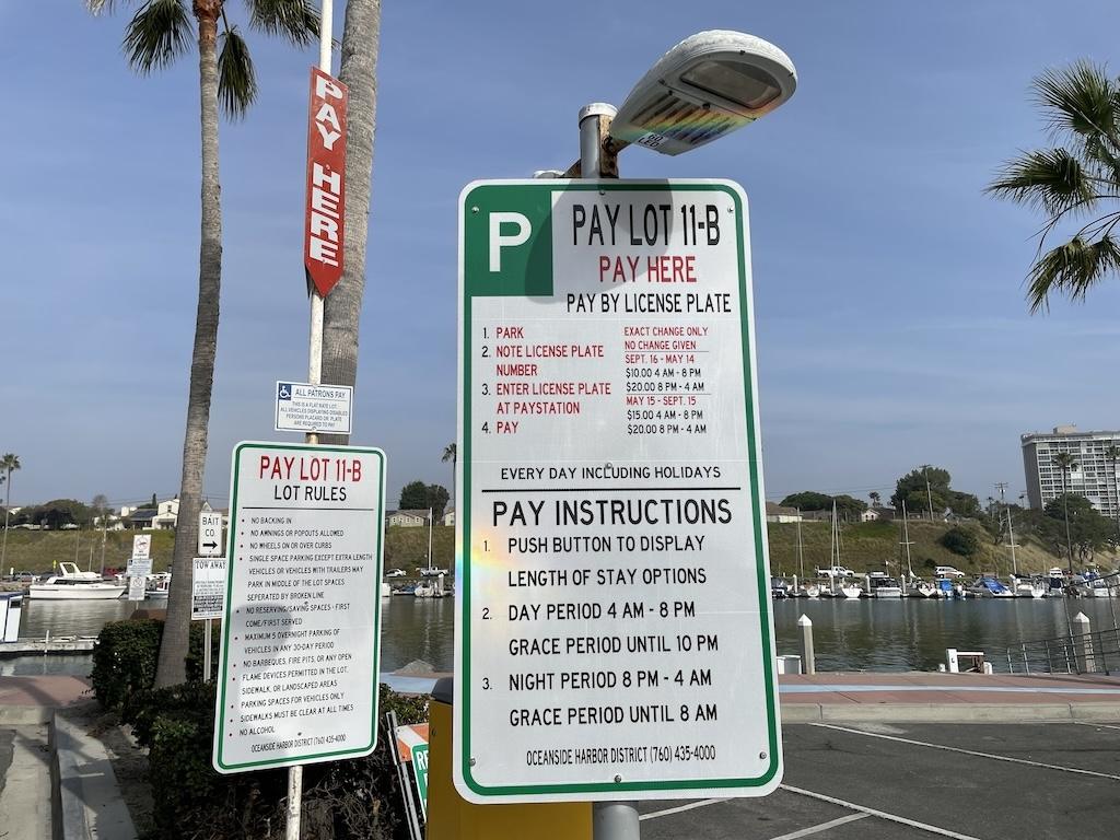 Parking sign in Oceanside Harbor overnight parking lot 11-B saying to pay by license plate