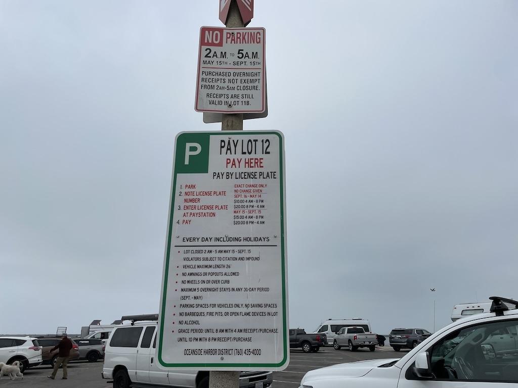 Sign at Oceanside Harbor overnight parking Lot 12 that says no parking 2 AM to 5 AM May 15 to September 15