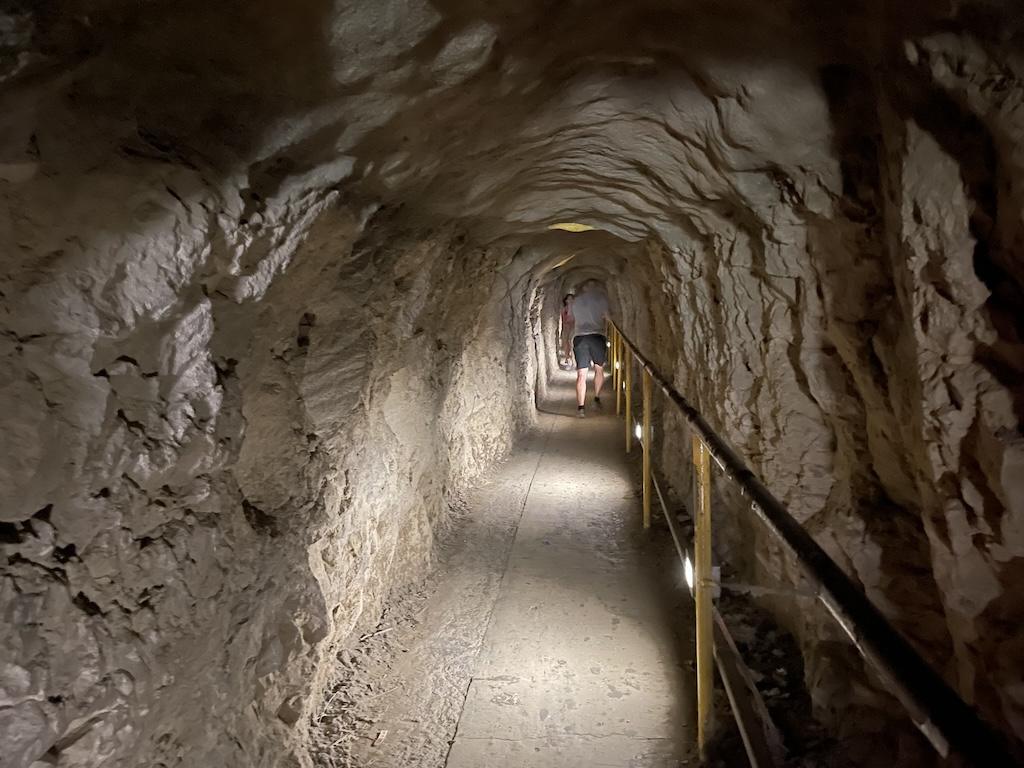 Man inside the tunnel hiking Diamond Head State Monument and heading to the summit