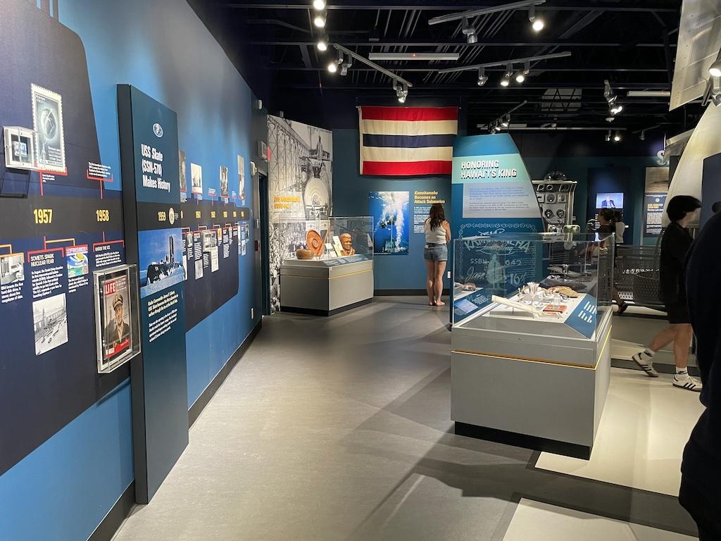 People looking at displays inside the Pacific Fleet Submarine Museum at Pearl Harbor in Oahu, Hawaii