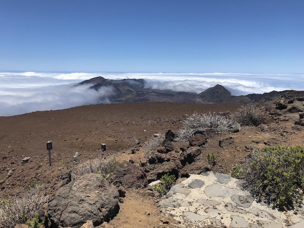 Clouds and brownish red landscape at Haleakala National Park in Maui, Hawaii