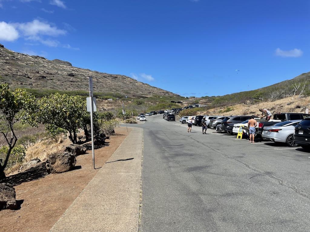 View of the parking area at the trailhead of the Makapu'u Lighthouse Hike where Luna saw a man selling water and goat tied to tree