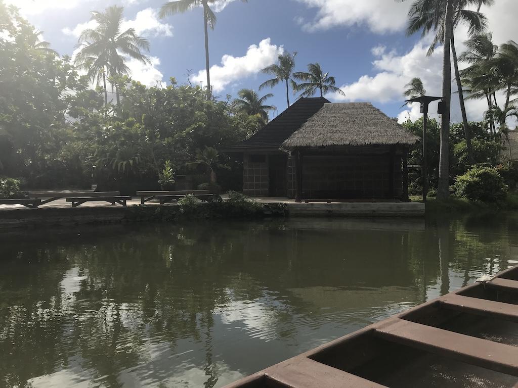 Straw topped hut across the lagoon at the Polynesian Cultural Center on Oahu, Hawaii