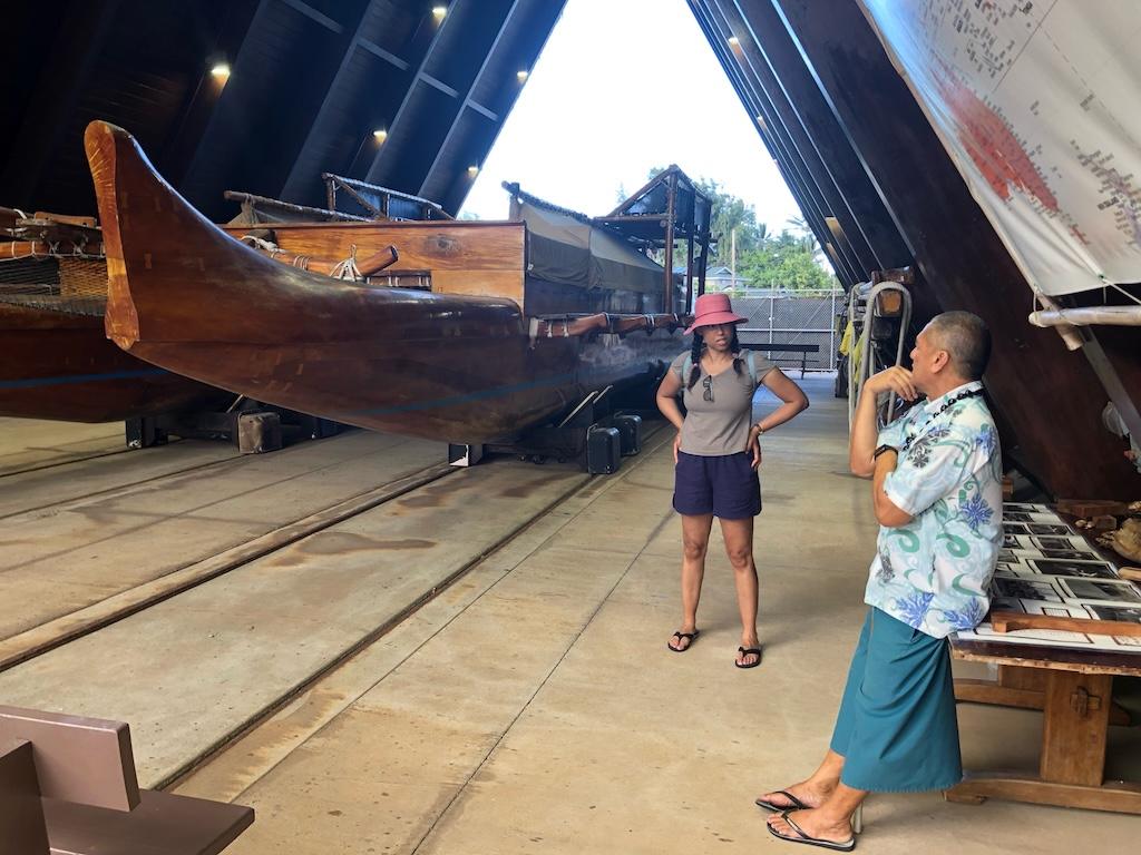 Luna talking to a worker at the Iosepa canoe at the Voyage of Discovery at the Polynesian Cultural Center on Oahu, Hawaii