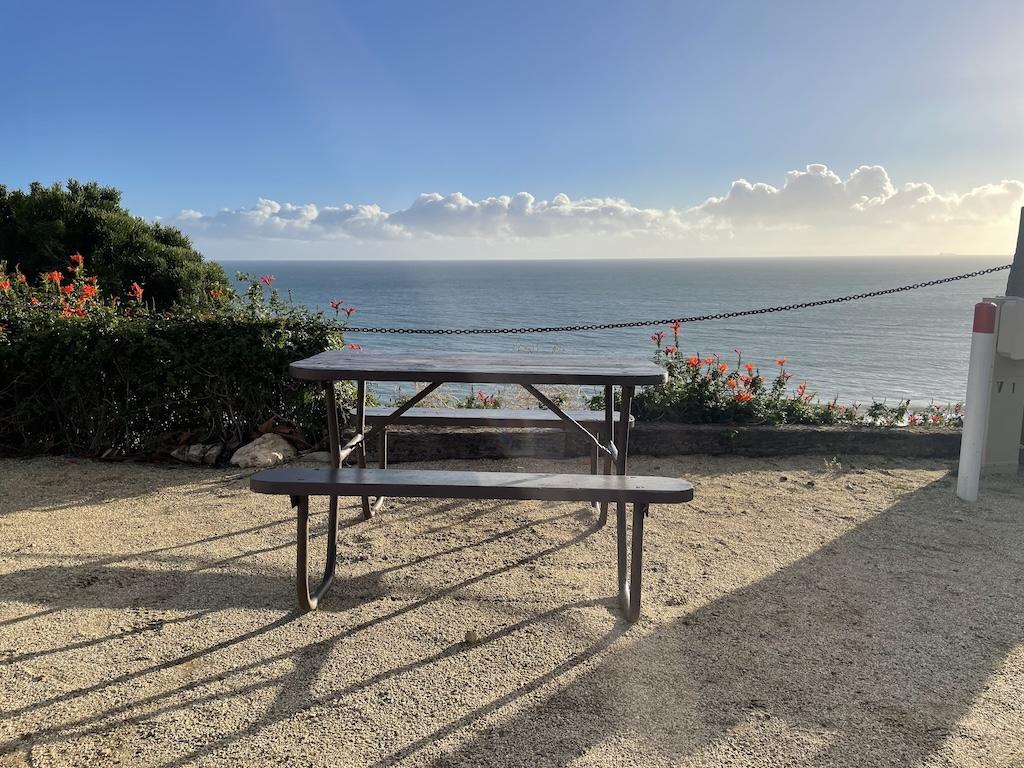 Picnic table at Surf Outpost and ocean view off the Pacific Coast Highway in Malibu, California.