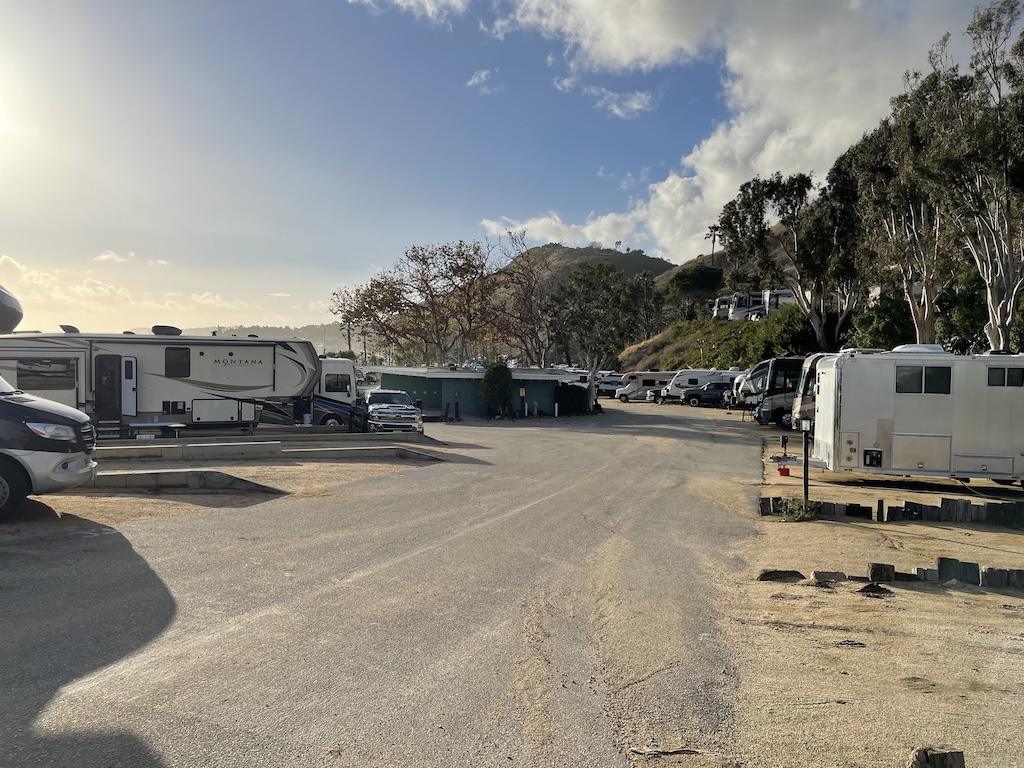 Road at Surf Outpost with RVs and campers parked in spots with bathroom in the distance