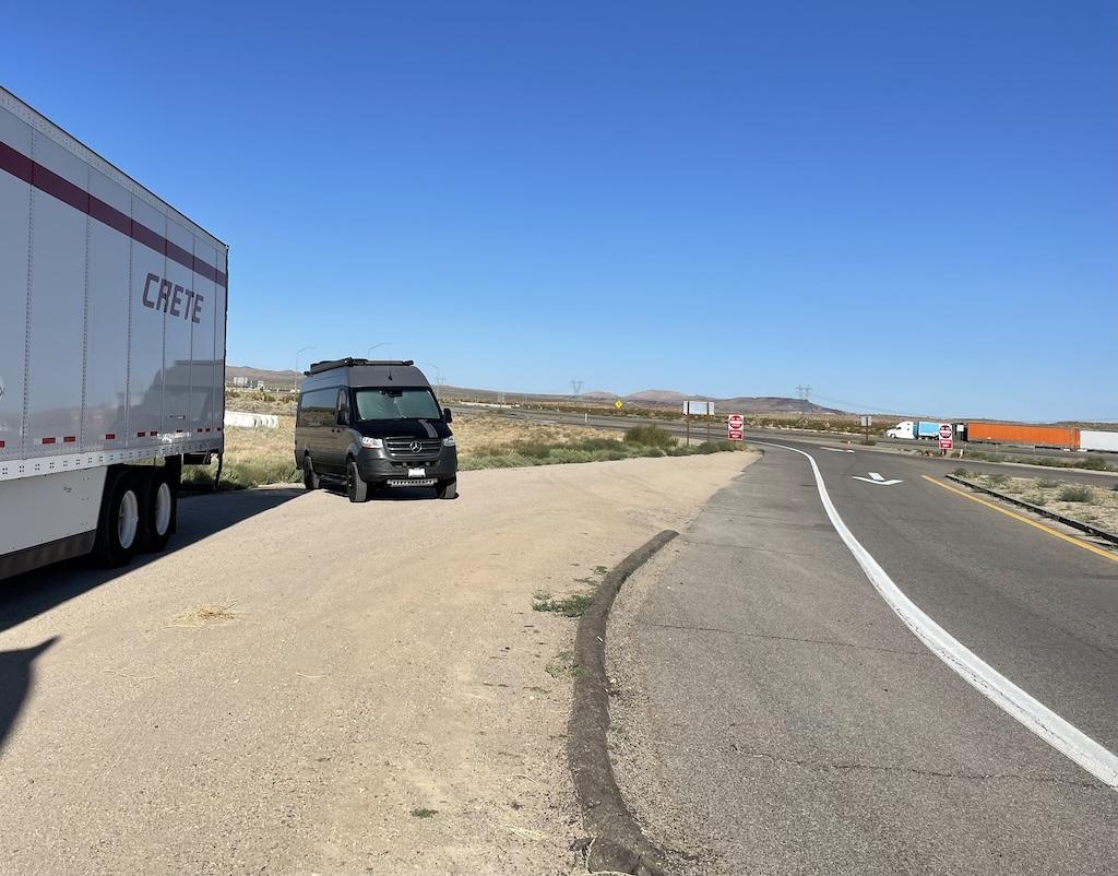 Luna’s sprinter van parked behind a semi-truck at the Wells Valley rest area in California