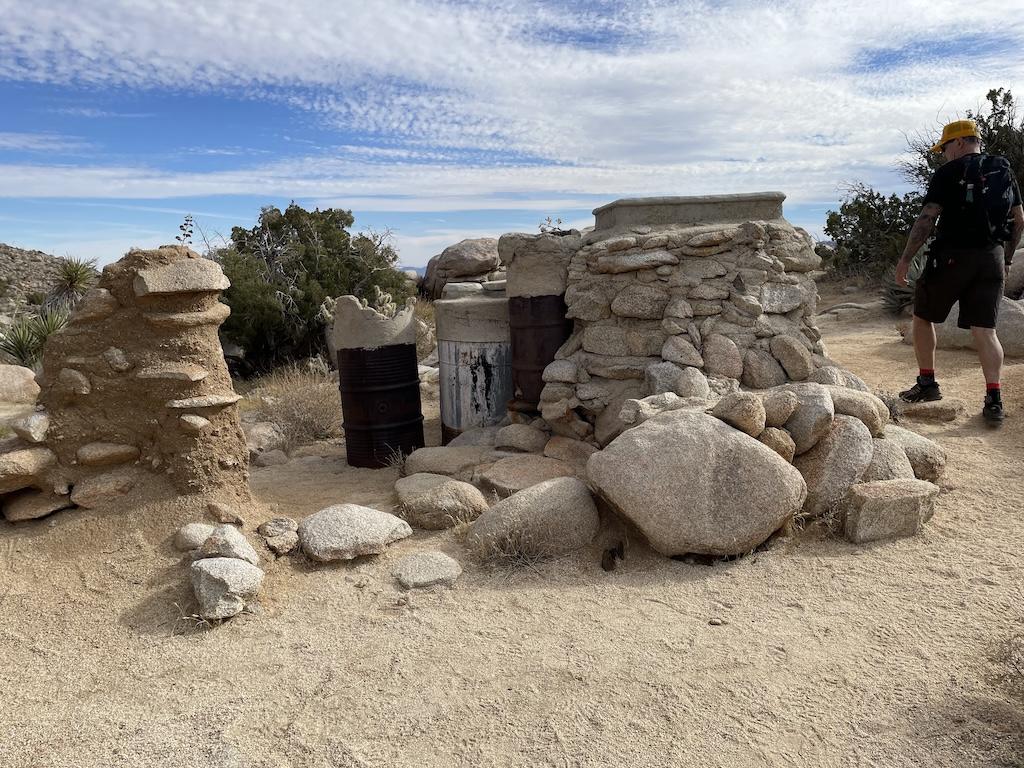 Man looking at the remains of the Yaquitepec, Marshal South home in  Anza-Borrego Desert State Park in California