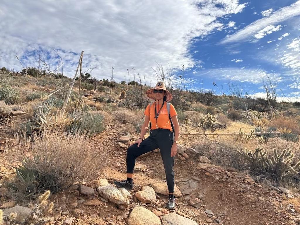 Luna making a hiker pose on the rocky and uneven Ghost Mountain Trail in Anza-Borrego Desert State Park in California
