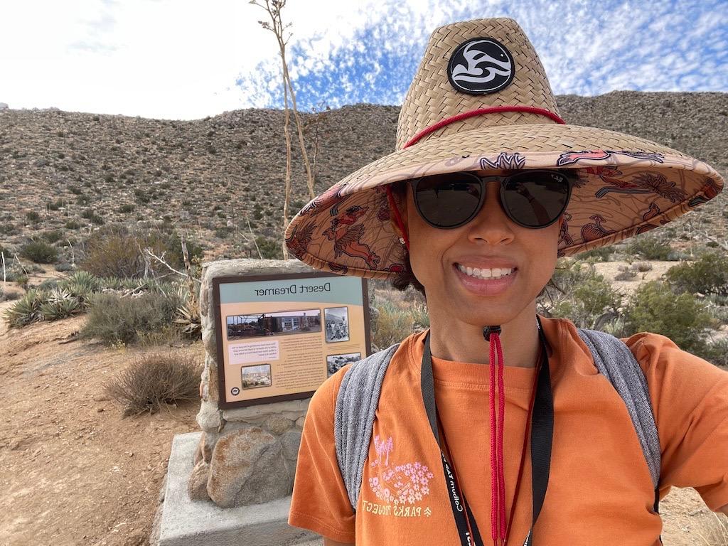 Luna smiling and wearing a sunhat at the Ghost Mountain Trail head in Anza-Borrego Desert State Park in California