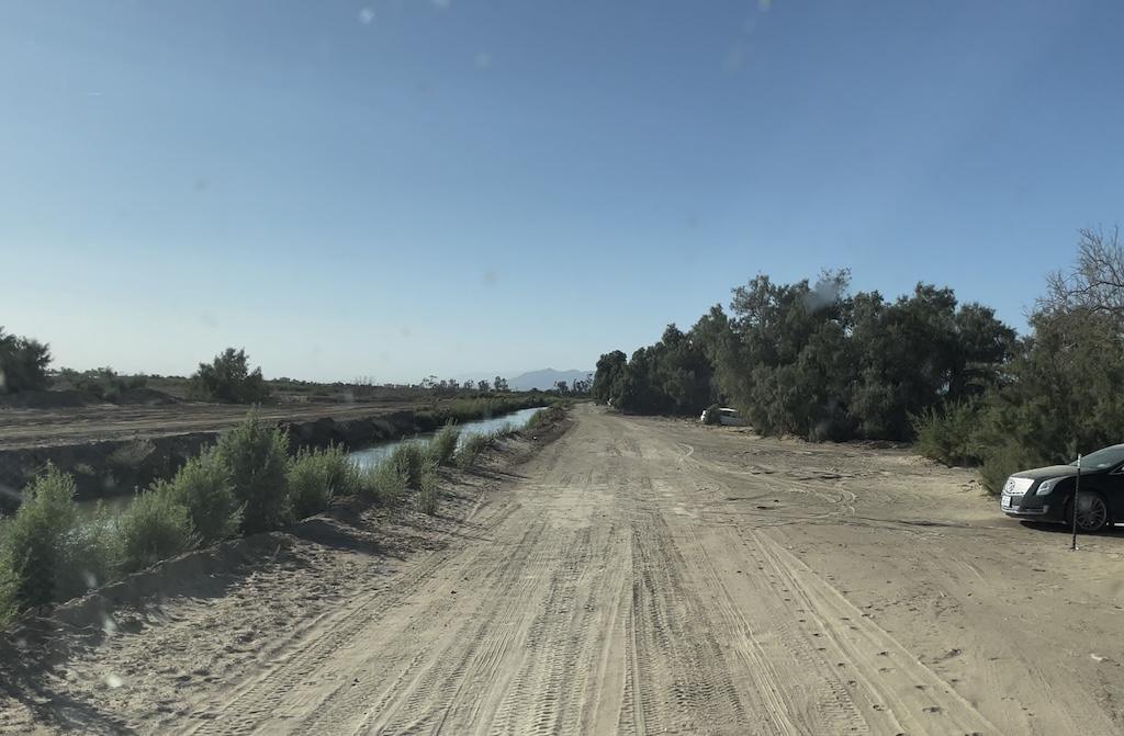 View from inside Luna’s van down the dirt road while traveling through Niland, California visiting Slab City