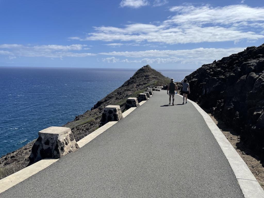 People walking in the far distance on the trail for the Makapu’u Lighthouse hike in Oahu, Hawaii
