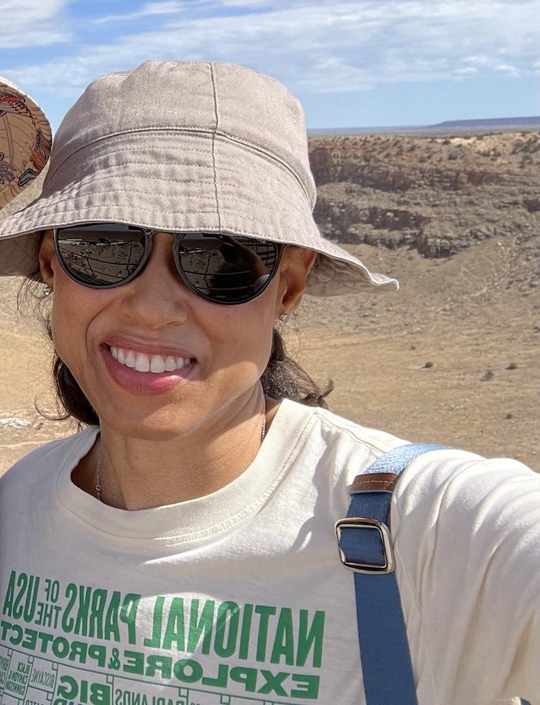 Selfie of Luna smiling to the camera in front of lookout point at Meteor Crater Natural Landmark in Arizona