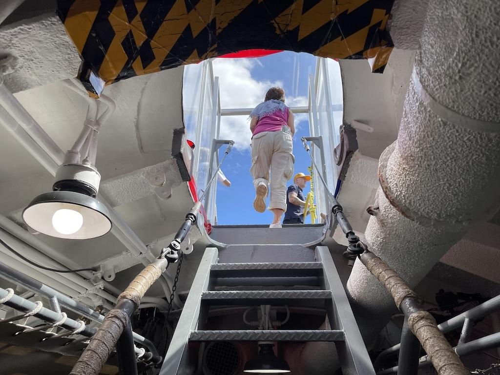 View of lady walking up the stairs leading out of the USS Bowfin at Pearl Harbor in Oahu, Hawaii
