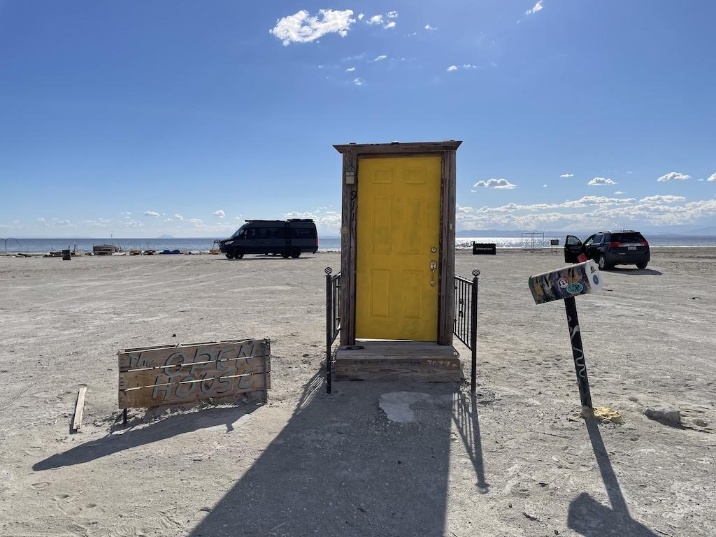 Open House exhibit with a door in the middle of the beach at Bombay Beach in California