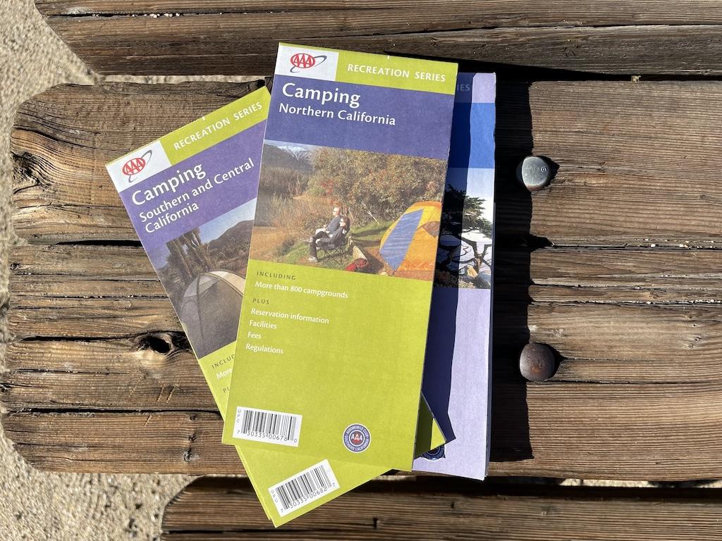 Maps on a picnic table that Luna uses while van camping