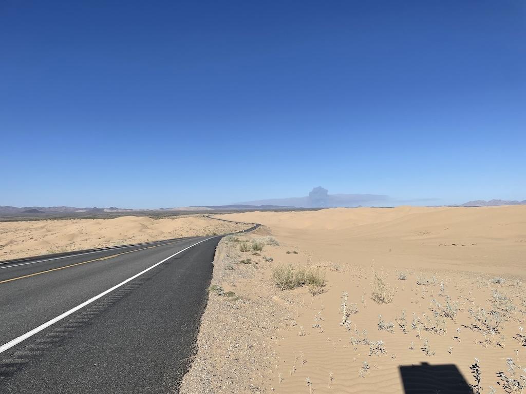 View down highway 78 and a large black smoke cloud that Luna saw at Glamis Sand Dunes, in California