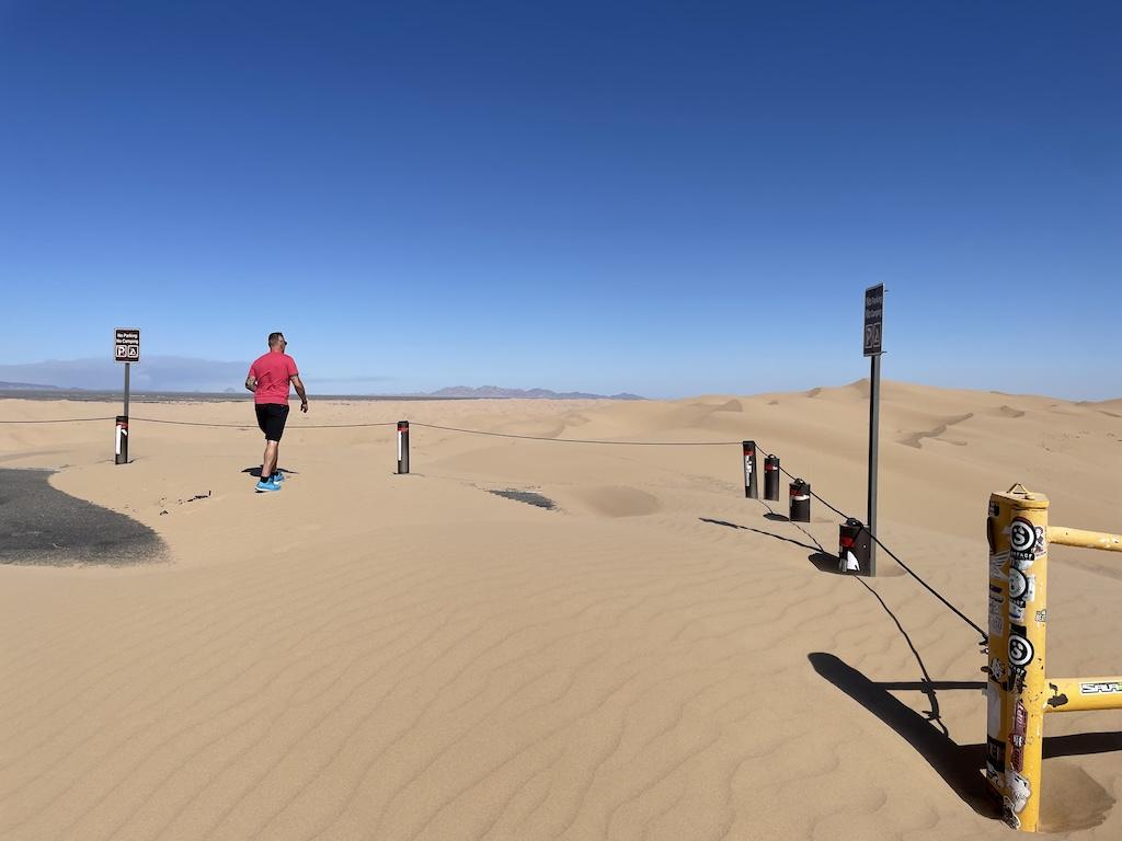 Man walking in the sand at Hugh T. Osborne Lookout Park at Glamis Sand Dunes, in California