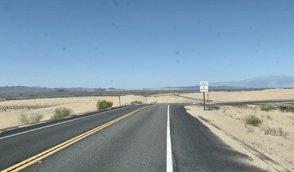 View from Luna’s camper van traveling down highway 78 to Glamis Sand Dunes with sand on the side of the road
