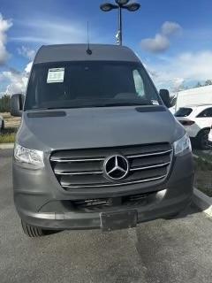 Front view of Luna’s Mercedes sprinter van in the dealership lot in which they bought it used