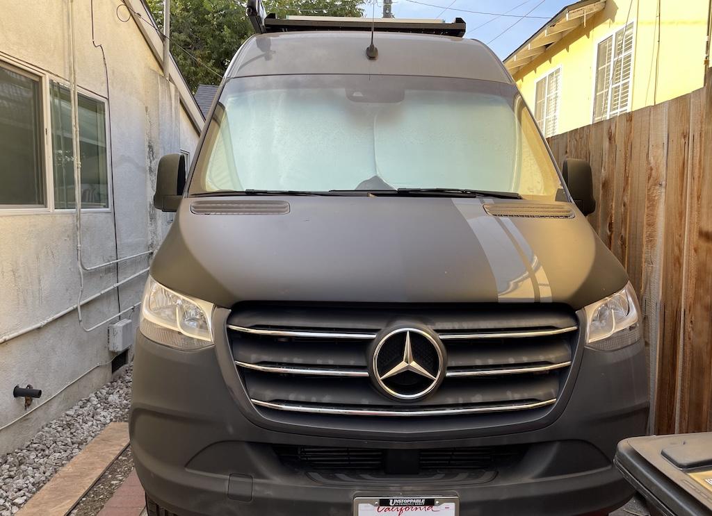 View of Luna’s Mercedes Sprinter van parked in the driveway next to the house