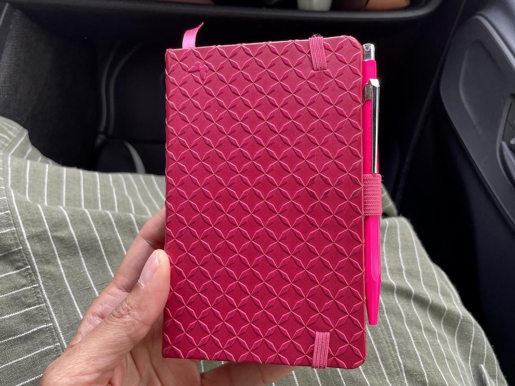 Luna’s pink journal she uses to write down travel notes 