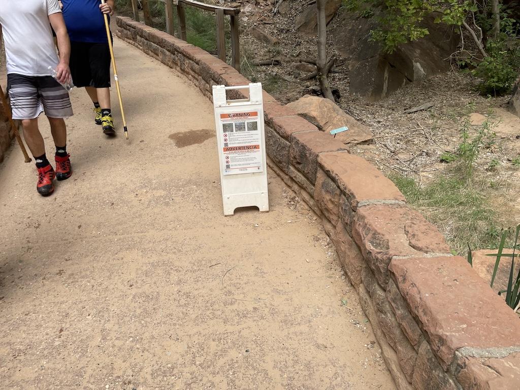Sign on the trail of the Riverside Walk at Zion National Park warning people of the high bacteria in the water