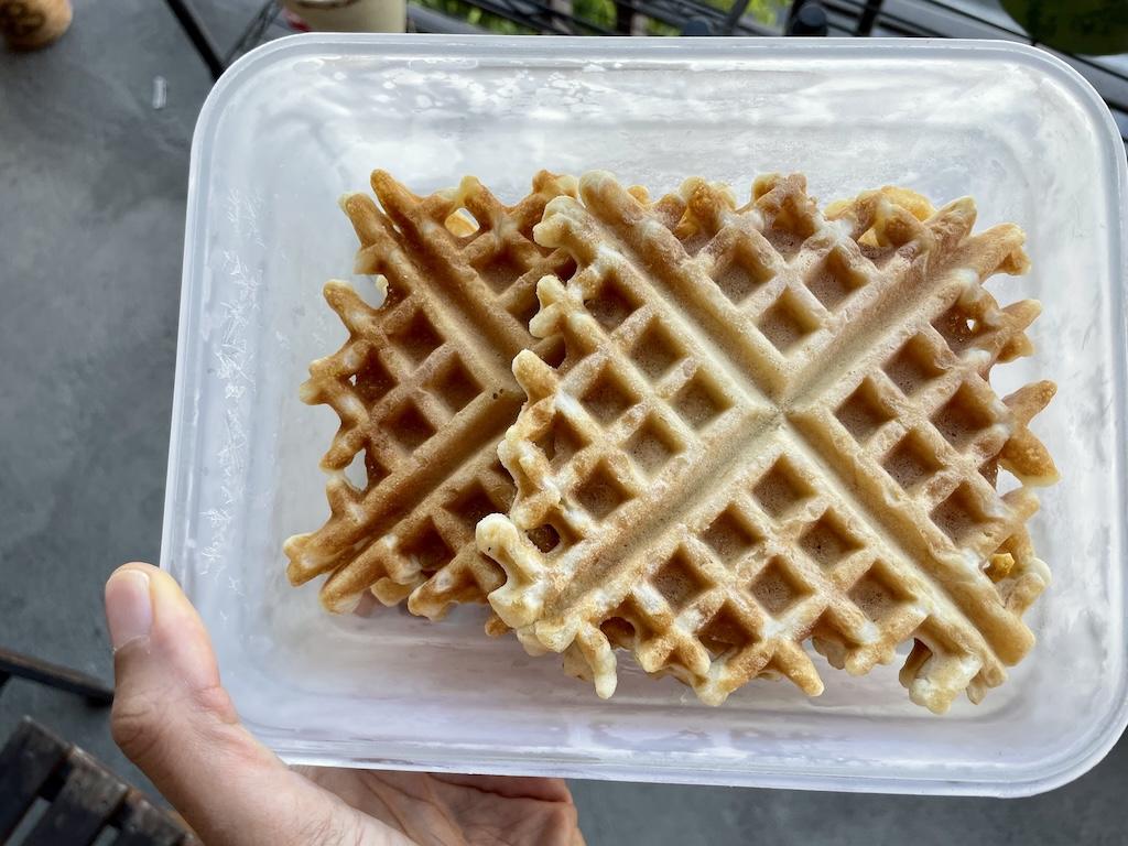 Close up view of Luna’s homemade gluten free waffles that she froze and stored in a glass container