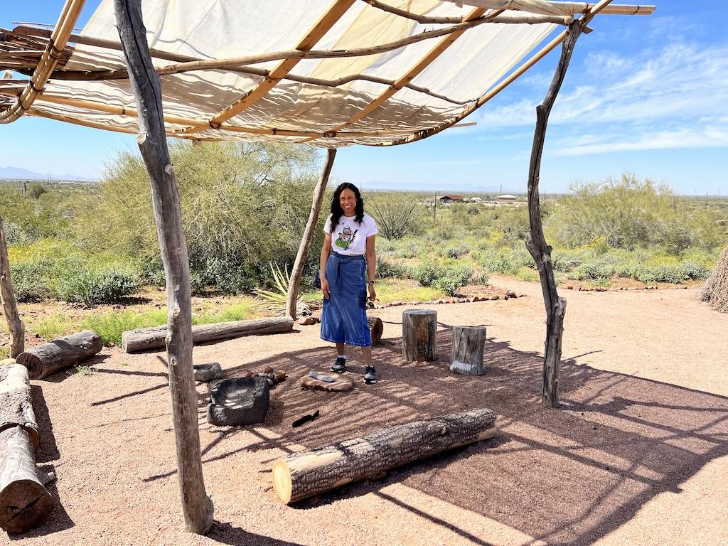 Luna smiling to the camera under an Apache tarp at the Superstition Mountain Museum in Arizona