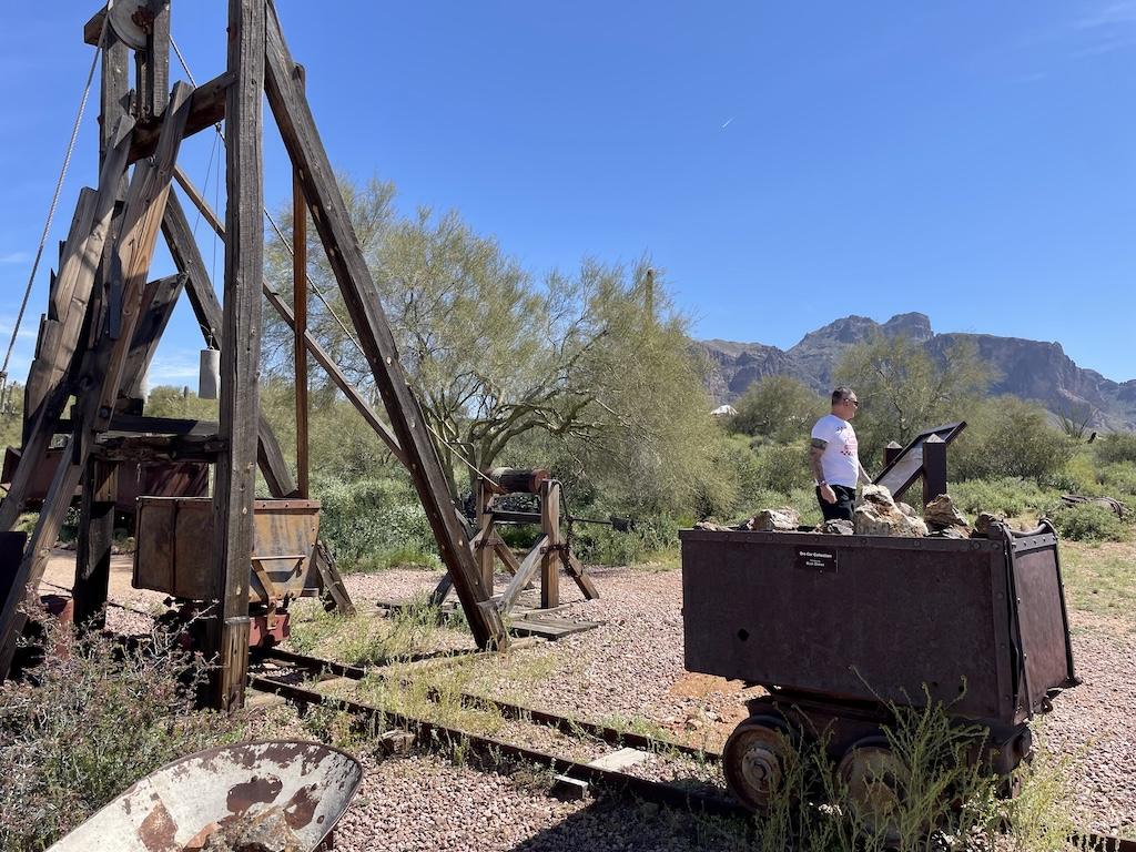 Man looking around at mining equipment and tools at the Superstition Mountain Museum in Arizona
