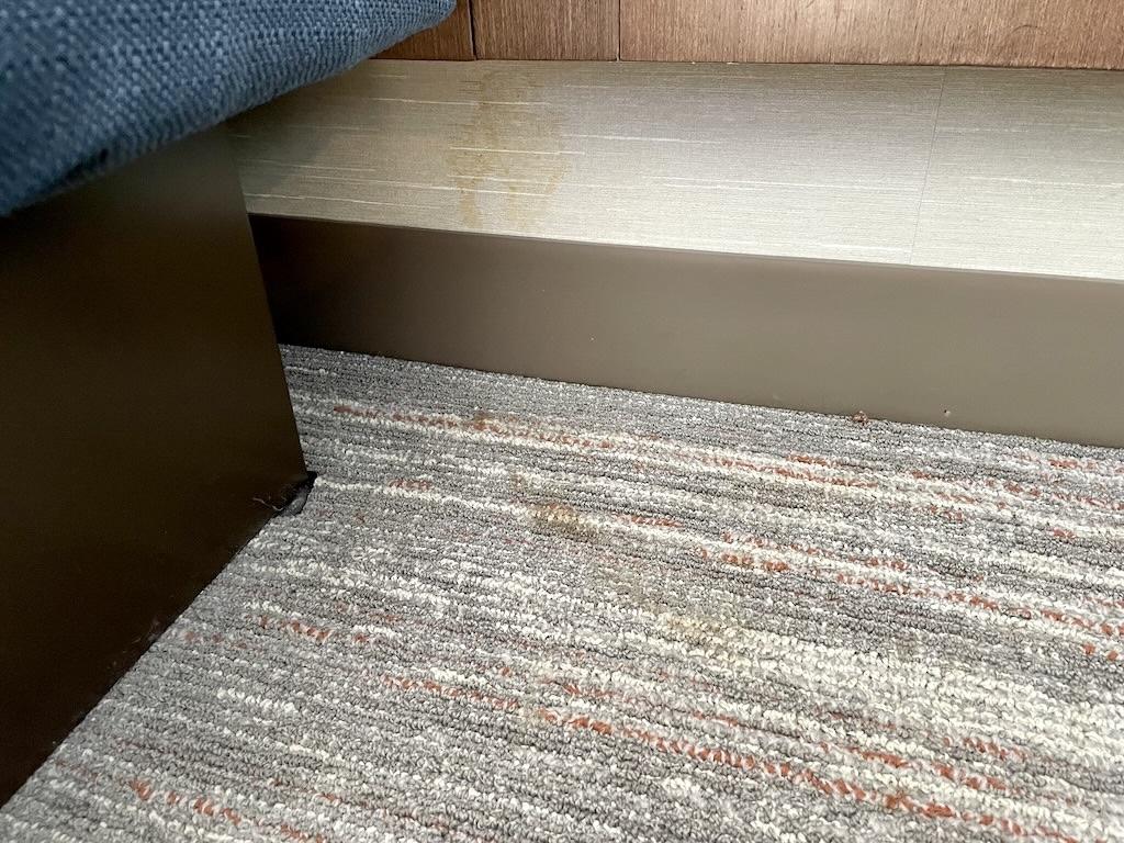 Brown fluid on wall and carpet near bed in hotel room that Luna stayed at in the Midwest