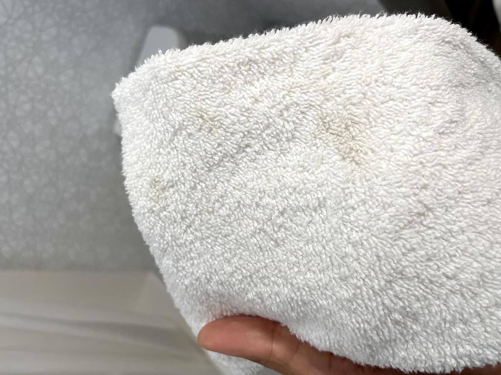 Brown stains on towel in hotel room that Luna stayed at in the Midwest