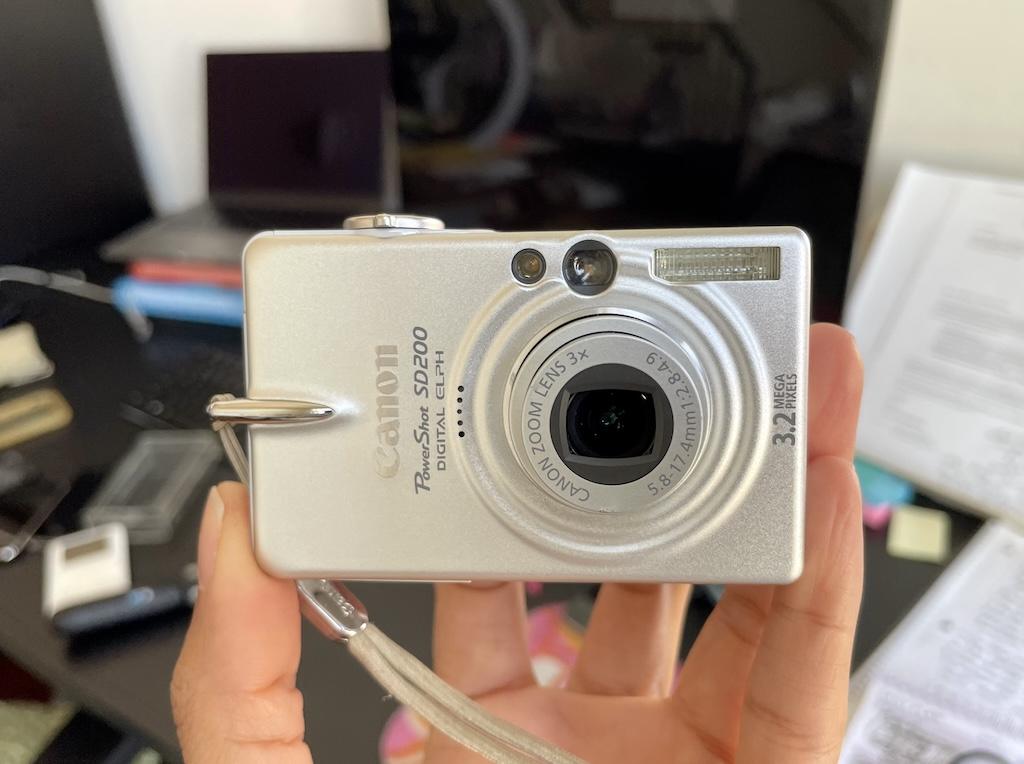 Luna’s hand holding her old Canon Powershot Digital camera