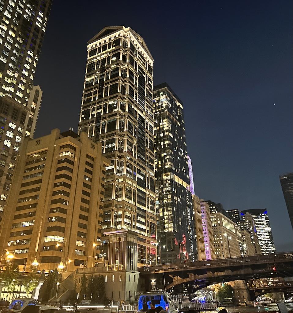 View of buildings lit up at night on the Chicago architecture river tour in Illinois