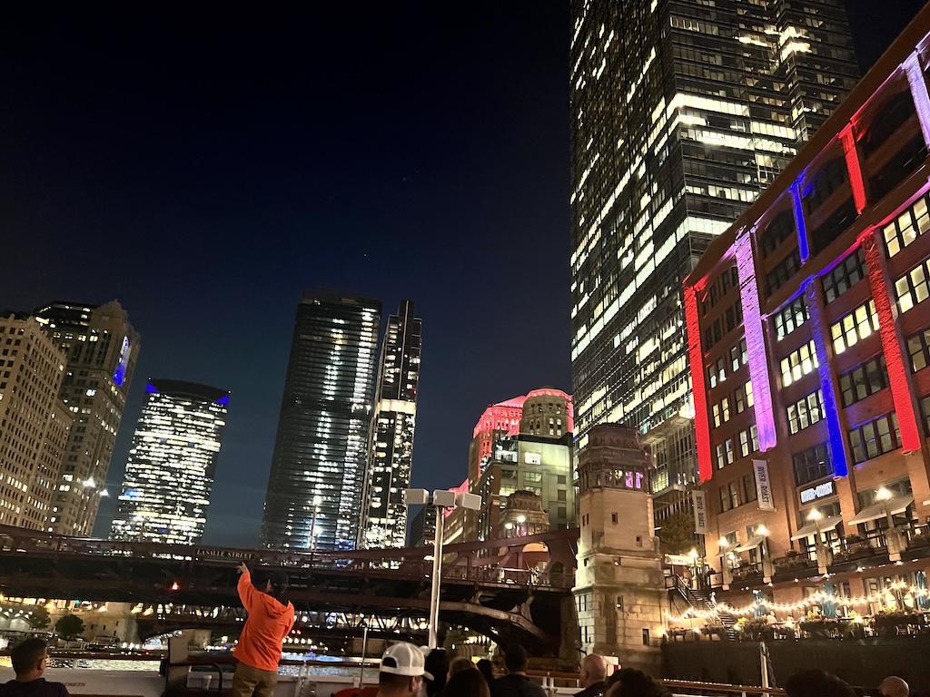 View of buildings at night on the Chicago architecture river tour Luna took with Shoreline Sightseeing in Illinois