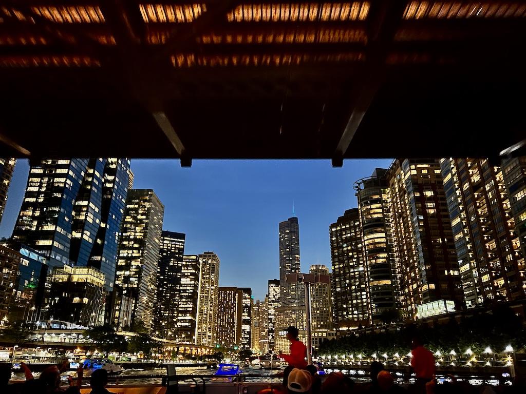 View of going under a bridge and seeing buildings at night on the Chicago architecture river with Shoreline Sightseeing in Illinois
