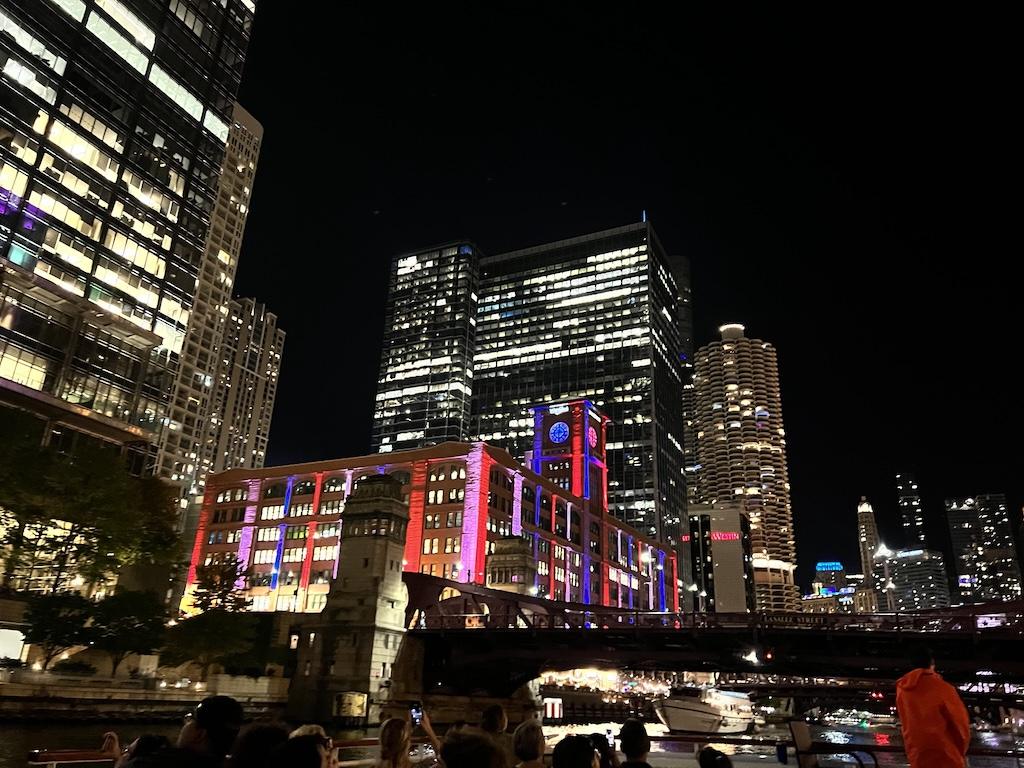 View of colorful buildings at night on the Chicago architecture river in Illinois