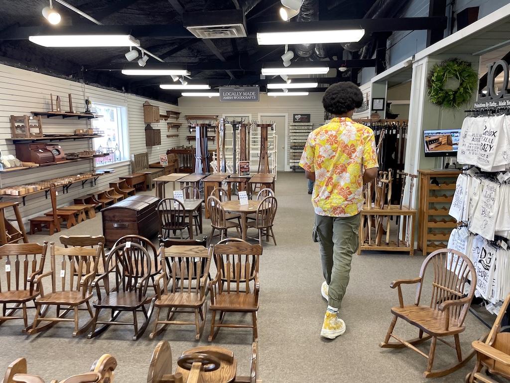 View of person walking through store with handmade wood and leather items in Shipshewana, Indiana