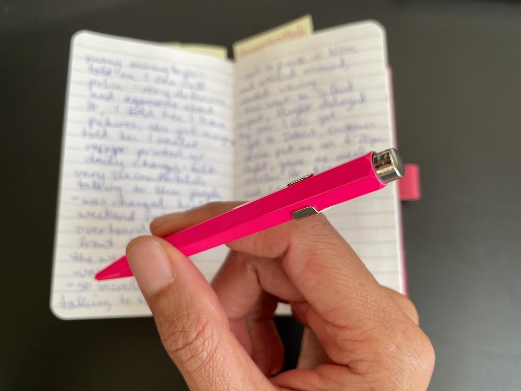 Close up of Luna’s pink pen and journal that she writes in in the background