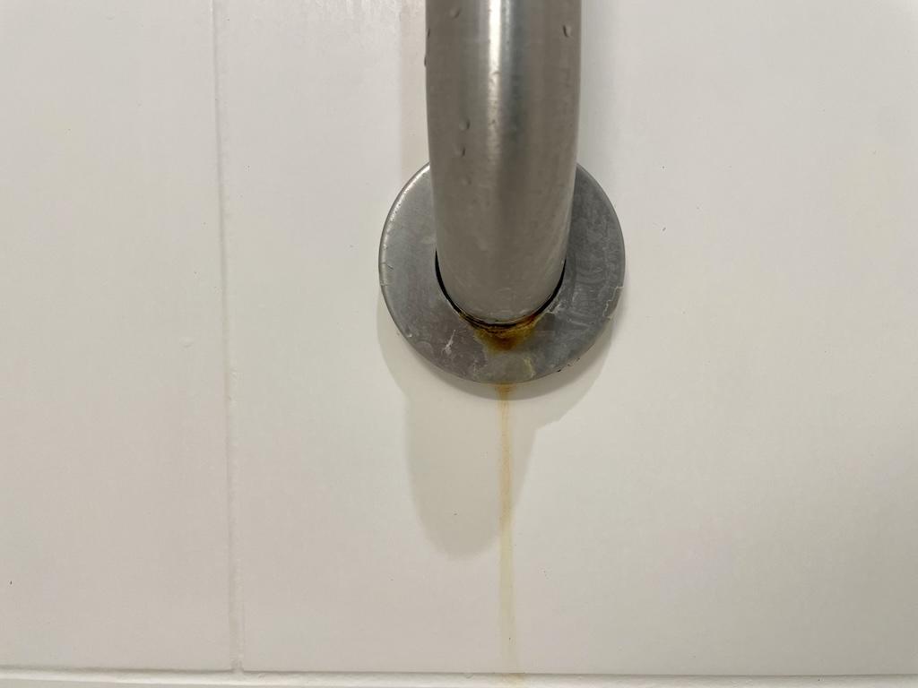 Rust running from shower handle in hotel room that Luna stayed at in the Midwest
