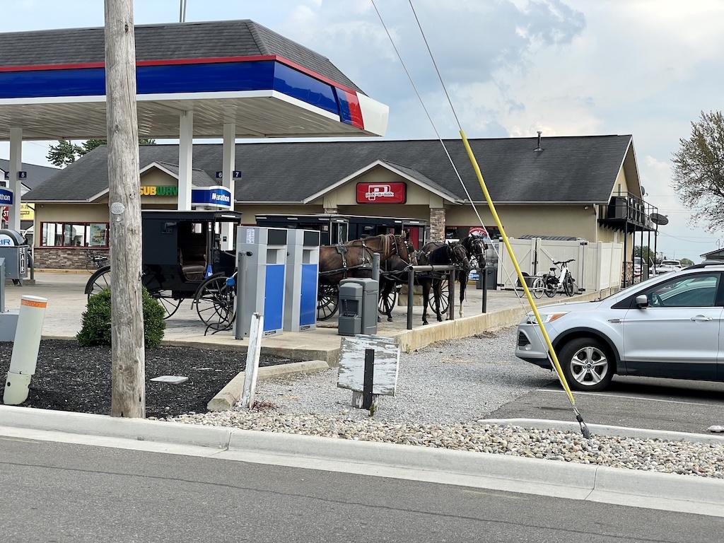 View of horse-drawn buggy at gas station in Shipshewana, Indiana 