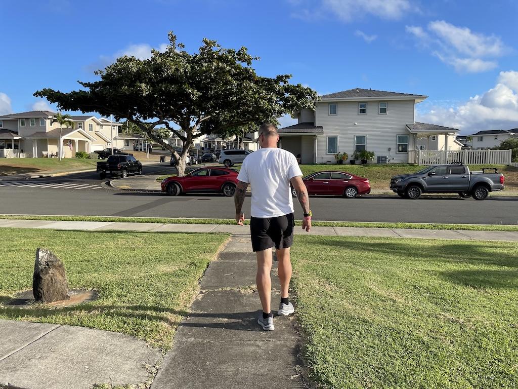 Man walking by houses at Marine Corps Base Hawaii in Oahu
