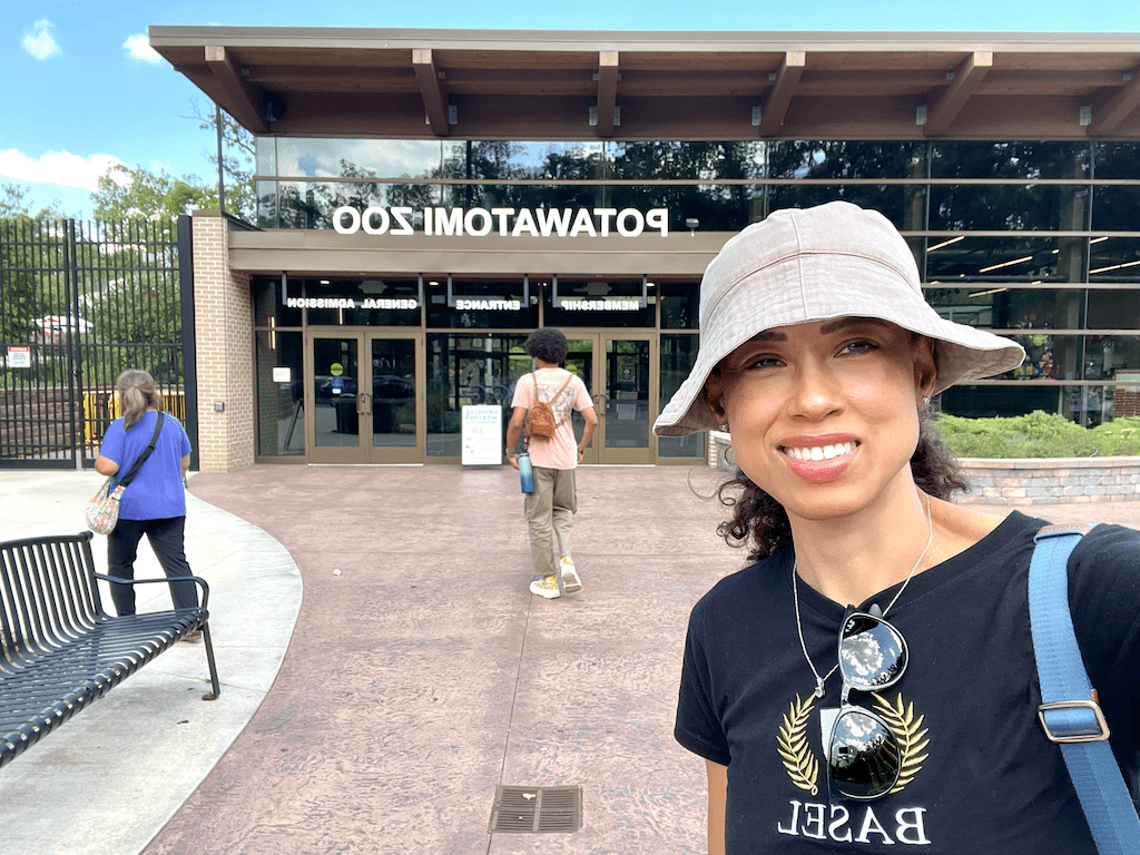Luna smiling to the camera in front of the Potawatomi Zoo entrance in Indiana