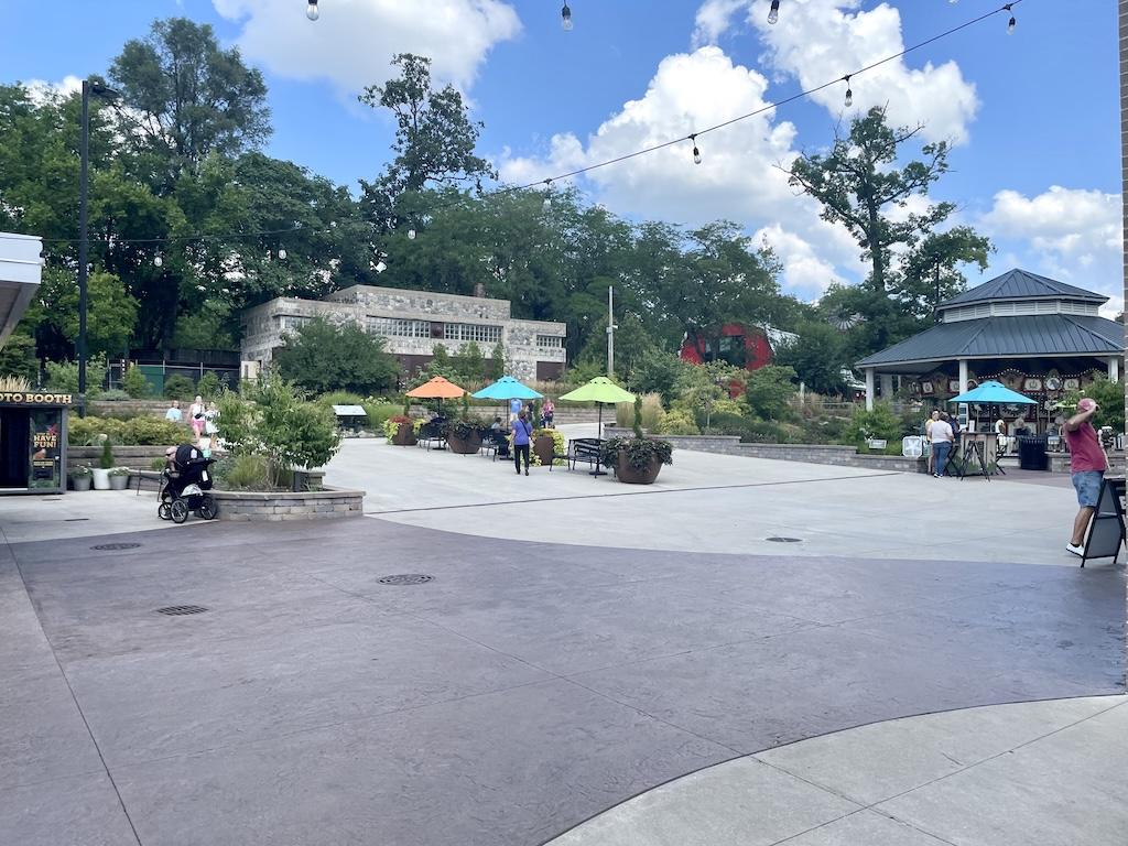 View of people and merry-go-round in the distance at Potawatomi Zoo in Indiana