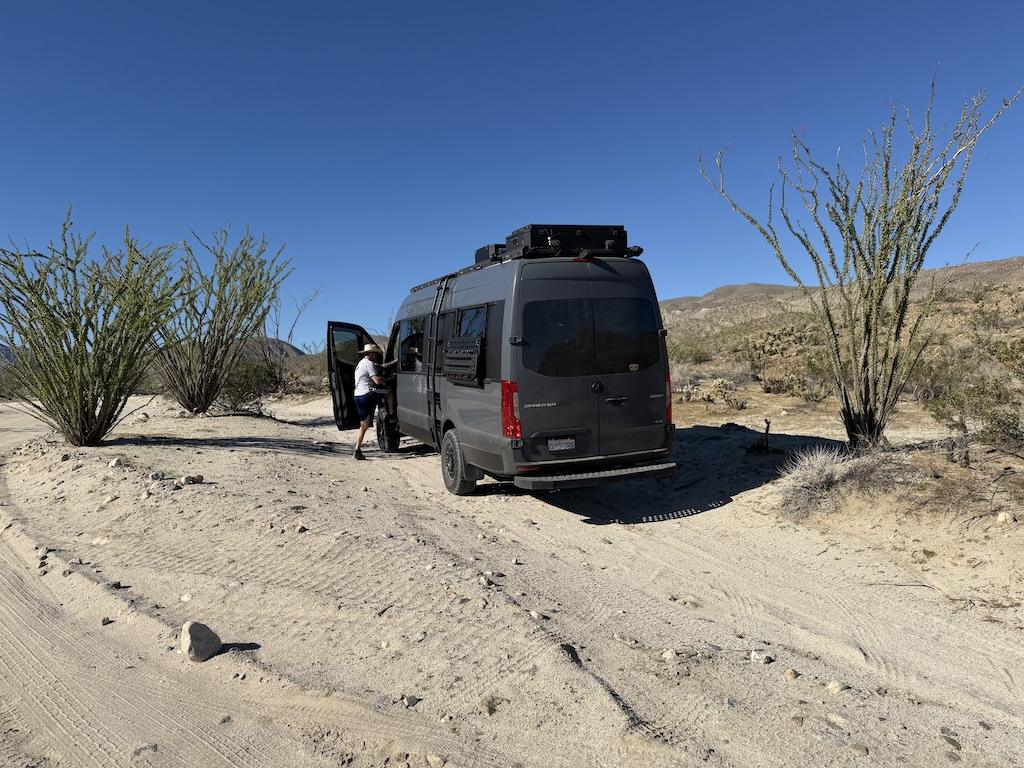 Man getting into a Sprinter van at Desert Gardens off Coyote Canyon, Anza-Borrego Desert State Park in California.