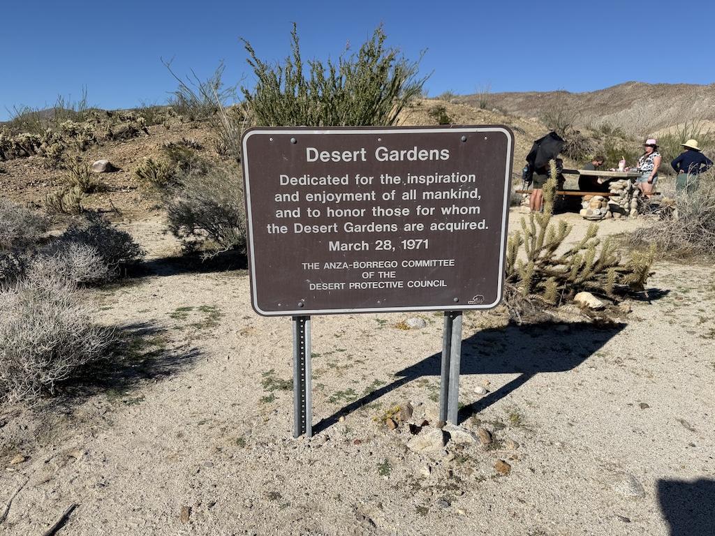 View Desert Gardens sign and people picnicing in the background Anza-Borrego Desert State Park in California.