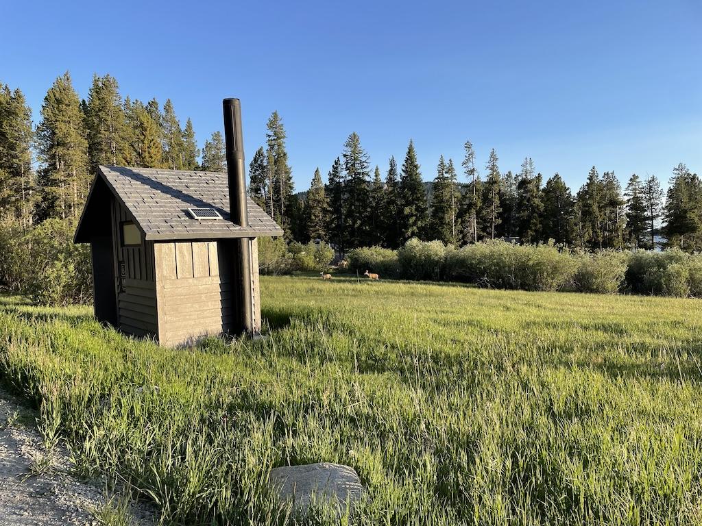 Bathroom at Lakeview Bighorn Campground, with deer in the background, near Meadowlark Lake, Wyoming