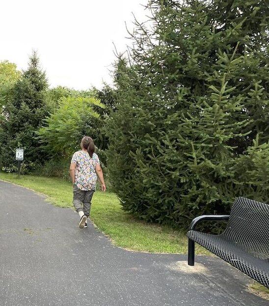 People walking around the path at Russom Park, in Dowagiac, Michigan