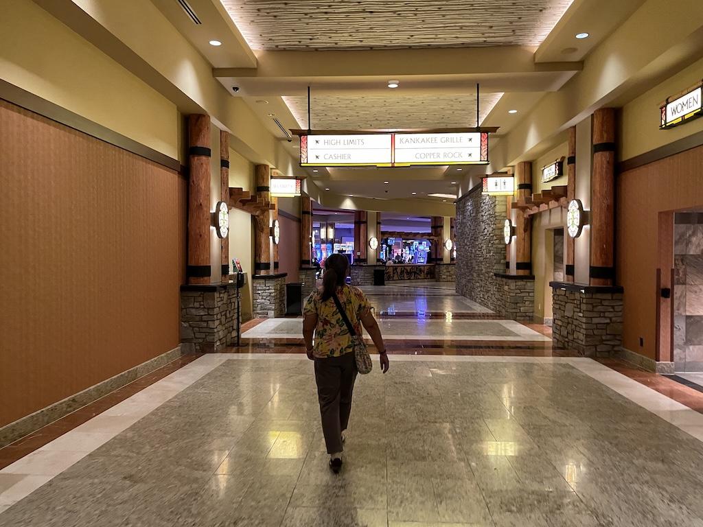 Woman walking down hallway leading to restaurants at Four Winds Casino South Bend, Indiana