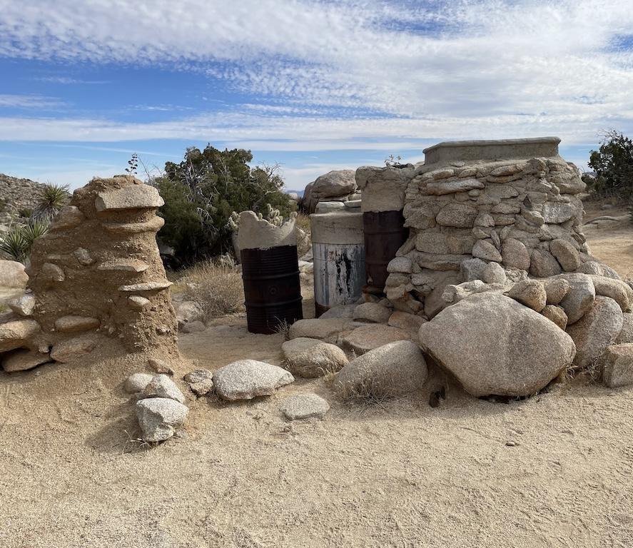Man looking at the remains of the Yaquitepec, Marshal South home in  Anza-Borrego Desert State Park in California